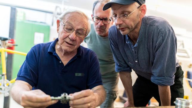 Beim Dreh in der Fahradwerkstatt: Armin Maiwald (links) mit Kameramann Kai von Westermann (rechts) und Toningenieur Peter Torringen (hinten).