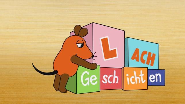 Maus lehnt sich auf bunte Bauklötze