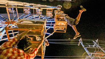 Zwei Männer hängen an einem Riesenrad