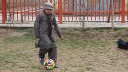 Fatima spielt mit einem Fußball.