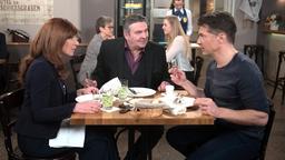 Carla (Maria Fuchs) lässt sich von Gregors (Wolfram Grandezka) und Nicos’ (Markus Graf, M. mit Komparsen, h.) Begeisterung mitreißen und einigt sich mit ihnen auf eine Big Fat Greek Wedding im Sommer.